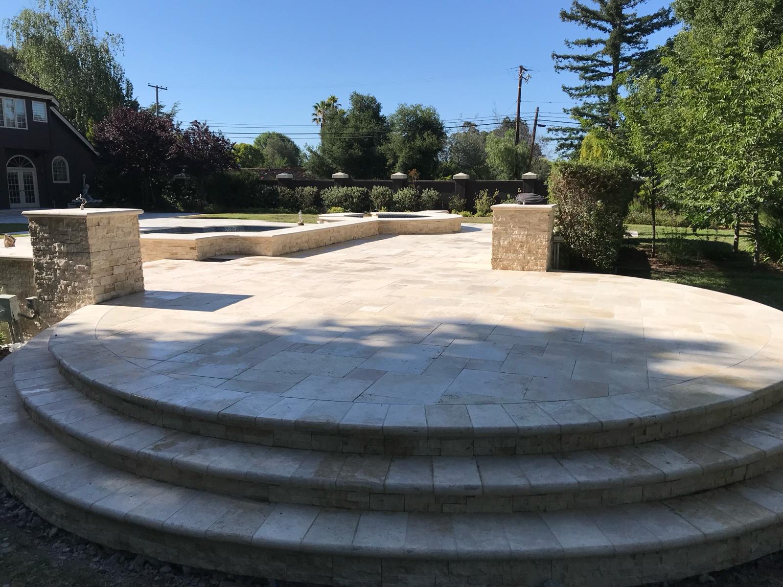 Travertine paver patio with rounded steps